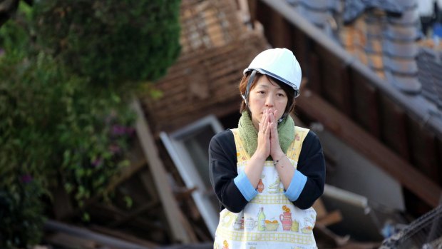 A resident in front of a damaged house in Mashiki, Kumamoto prefecture, in southern Japan on Saturday. 