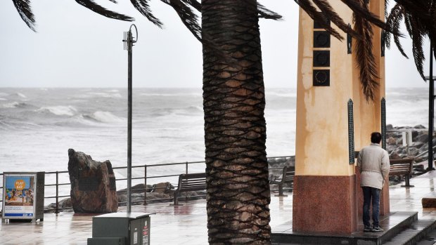 A man shelters from the winds near Brighton Jetty, Adelaide.