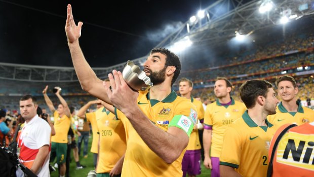 On song: The Socceroos celebrate after winning the Asian Cup in January.