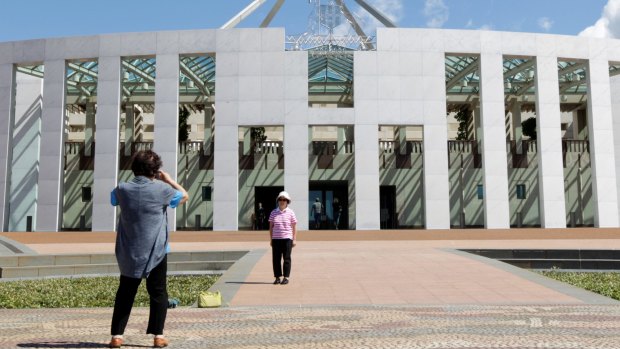 Tourists on the forecourt of Parliament House in Canberra.
