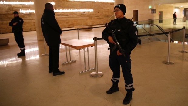 A police officer stands guard inside the Louvre Museum after the attack on Friday.