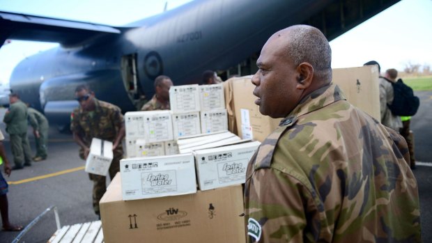 Officials offload relief supplies from a New Zealand military plane at the airport on Tanna.