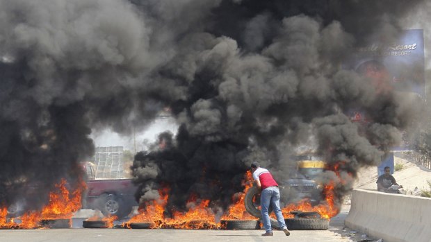 Demonstrators block Lebanon's main Mediterranean highway on Sunday. 
