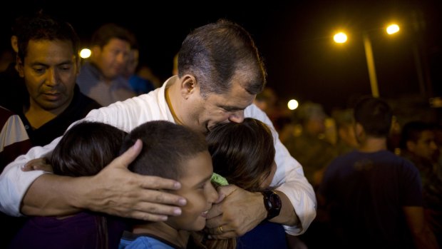 Ecuador's President Rafael Correa kisses a group of children in Portoviejo, Ecuador.