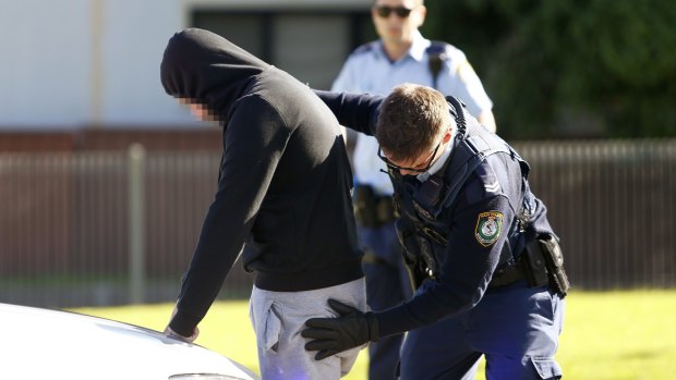 Police officers stopped various cars for searches as detectives raided homes on Gowrie Avenue at Punchbowl.