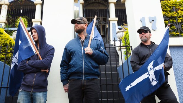 Protesters in Sydney hold Australia First Party flags.