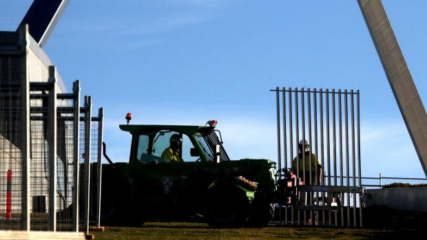 Workers installed the first section of a 2.6m high security fence at Parliament House.