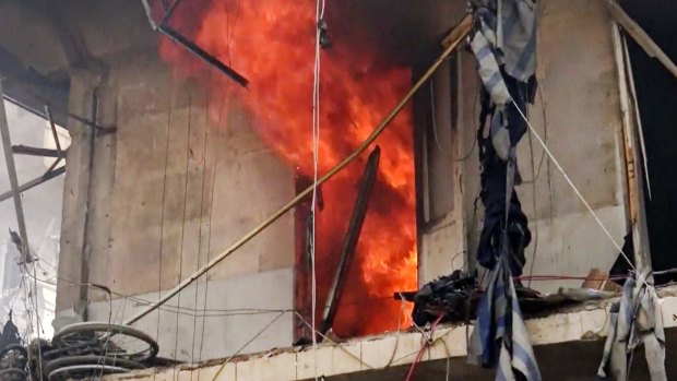 A building on fire after air strikes hit Aleppo.