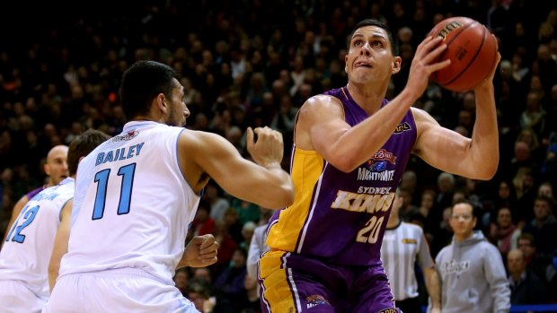 New recruit: Jeromie Hill takes a shot for the Sydney Kings while guarded by Duane Bailey.