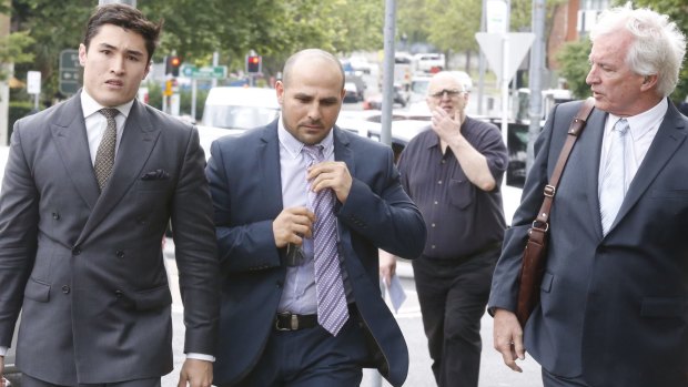 Not guilty plea: Hazem El Masri, centre, arrives at Bankstown Local Court last October.