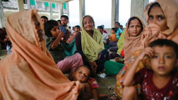 Members of Myanmar's Muslim Rohingya minority sit in a temporary shelter at Shah Porir Deep.
