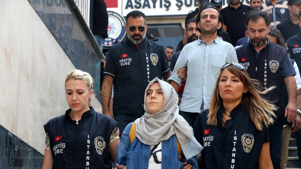 Police escort journalists to court in Istanbul on Friday. Twenty-one journalists were appearing in court after being detained as part of a sweeping crackdown following Turkey's failed military coup.