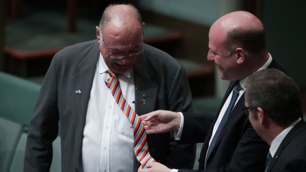 Liberal MP Trent Zimmerman looks at Warren Entsch's rainbow tie.