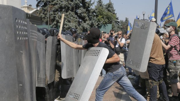 Ukrainian protesters, right, clash with police after a vote to give greater powers to eastern regions of Ukraine.