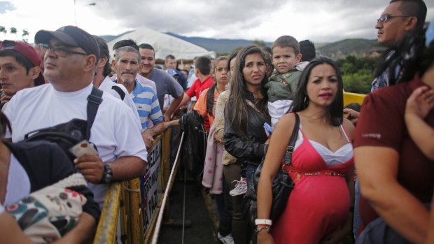 Venezuelans wait in line to cross into Colombia to hunt for food and medicine that are in short supply at home. 