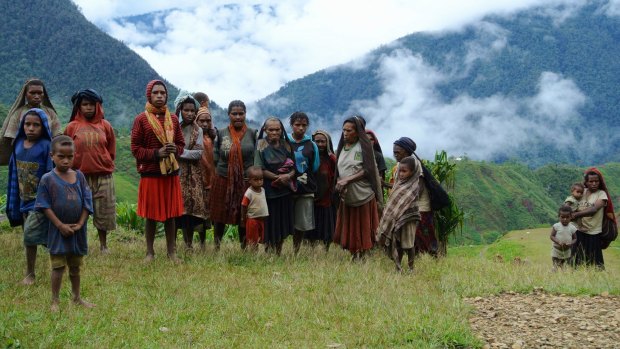 Wild side: Lolat villagers wait by their airstrip to greet the writer. 