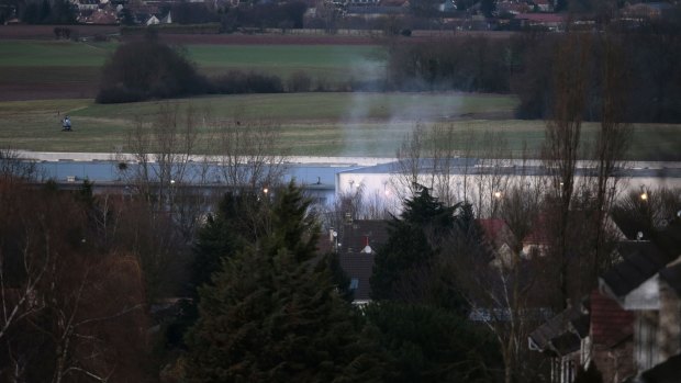 Smoke rises from a building in Dammartin-en-Goele, north-east of Paris, where two brothers suspected of killing 12 people in an Islamist attack on French satirical newspaper Charlie Hebdo held one person hostage.