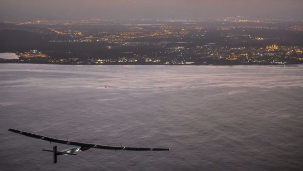 Grounded ... Solar Impulse 2, a plane powered by the sun's rays and piloted by Andre Borschberg, approaches Kalaeloa Airport near Honolulu on July 3 after its record-breaking flight from Nagoya, Japan.