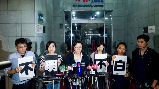 Ming Pao employees outside Ming Pao headquarters in Hong Kong. 