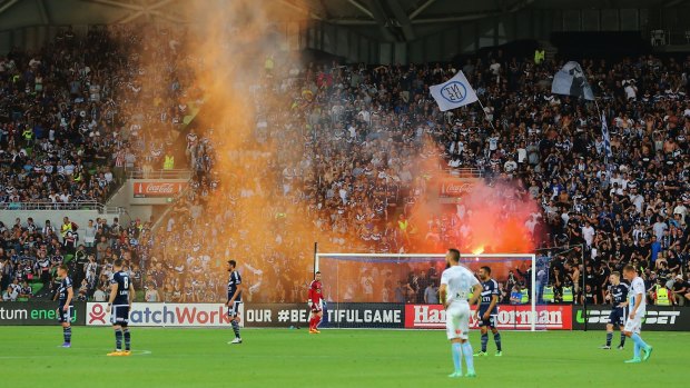 Victory fans let off a flare during goal celebrations at a match in February last year.