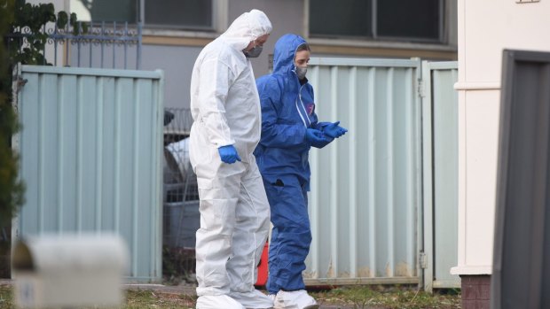Forensic police examine the scene of the shooting.