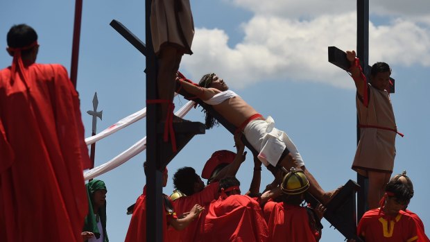 Reuben Enaje re-enacts Christ's crucifixion in Barangay San Pedro Cutud in Pampanga, north of Manila