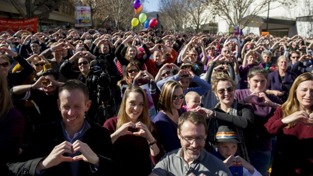 Canberrans, including Samantha and Hayley Wilson (third and fifth from left), at the Love in Canberra rally for marriage equality.