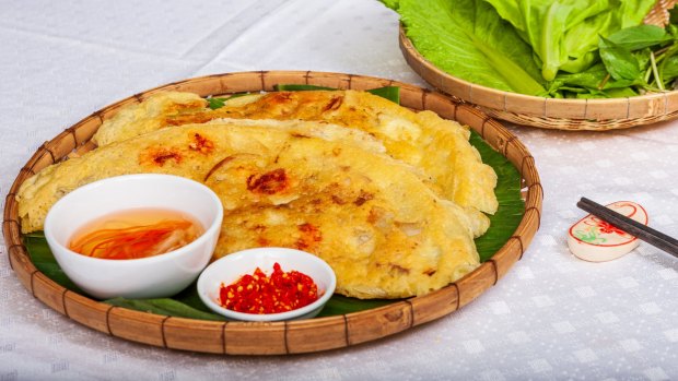 Banh xeo is a crisp, crepe-like disc made with rice flour, water and turmeric, and filled with savoury stuffings.