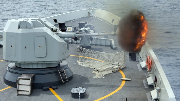 An anti-surface gun is fired from China's Navy missile frigate Yulin during "Exercise Maritime Co-operation 2015".