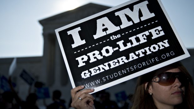 A pro-life advocate holds a sign outside the US Supreme Court before rulings in Washington, DC on June 27. 