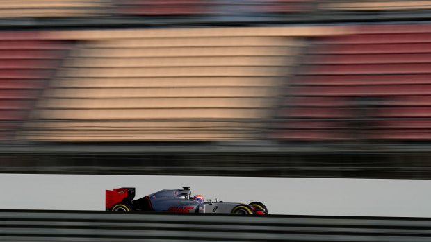 Motion blur:  Frenchman Romain Grosjean takes the new Haas car on a test run.