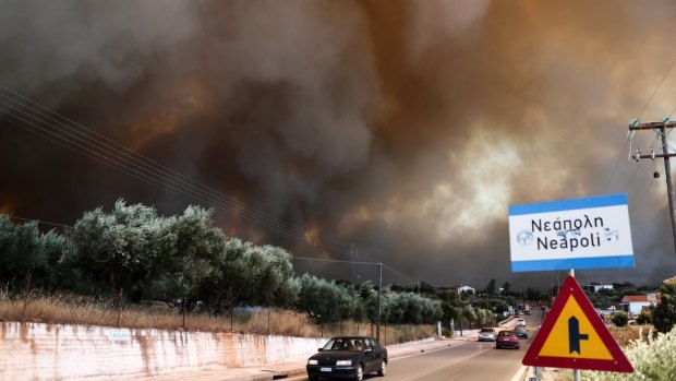 A fire burns over the town of Neapoli, southern Greece on Friday.