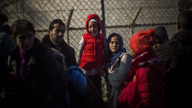 Refugees and migrants wait to enter a registration centre in Moria village on the Greek island of Lesbos on Tuesday.