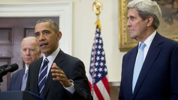 Barack Obama (centre) with Vice-President Joe Biden (left) and Secretary of State John Kerry on Friday.
