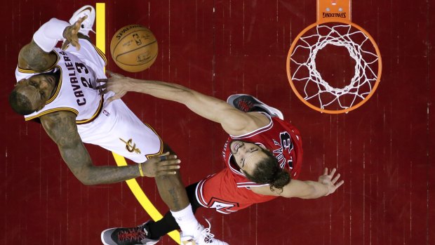 Tough work in the paint: Cleveland Cavaliers forward LeBron James shoots over Chicago Bulls centre Joakim Noah.