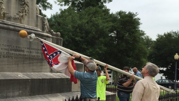 The Confederate battle flag being removed from the grounds of Alabama's state capitol on Wednesday. 