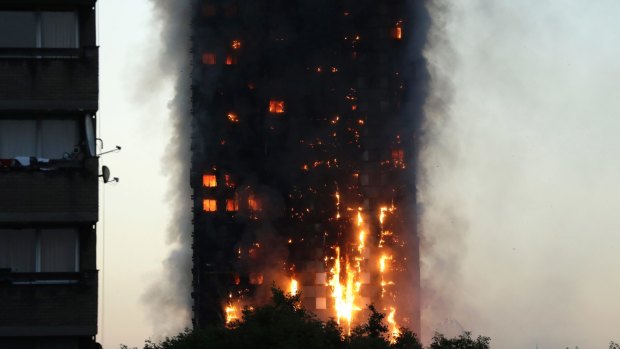 Smoke and flames rise from the building. 