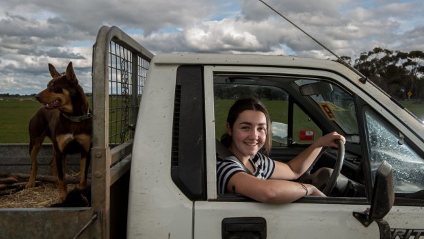 Charlotte Verley, 17, and sheepdog Bob on her family farm near Boort.