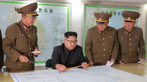 Kim Jong-un talks with military commanders during his visit to Korean People's Army's Strategic Forces in North Korea on August 14.