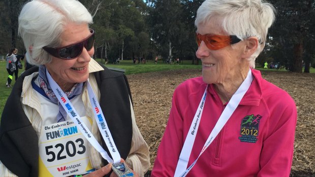Suzanne Counsel, left, and Anne Young, at the end of the Canberra Times 10km fun run on Sunday, their 30th event.
