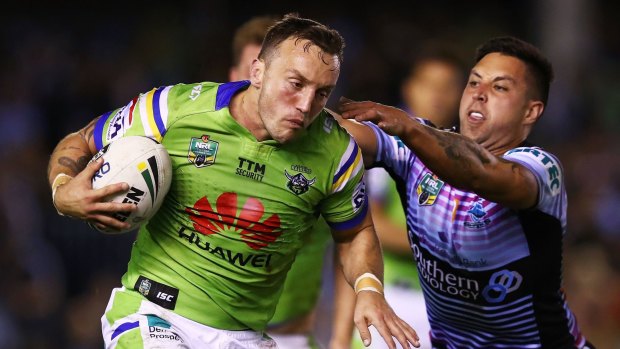 Josh Hodgson of the Raiders runs the ball against the Cronulla Sharks.