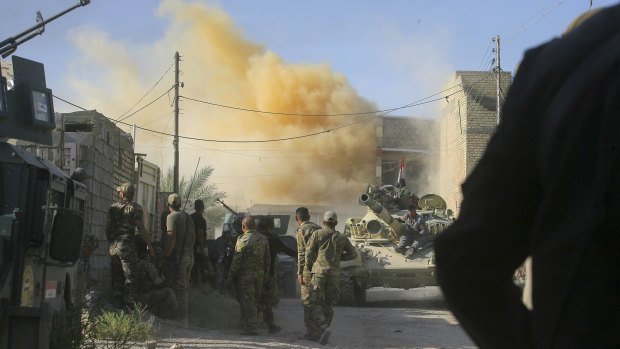 Smoke rises after an airstrike as Iraqi security forces advance.