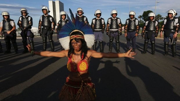 A Pataxo indigenous woman performs in front of a heavy police presence during protests in Brasilia last month.