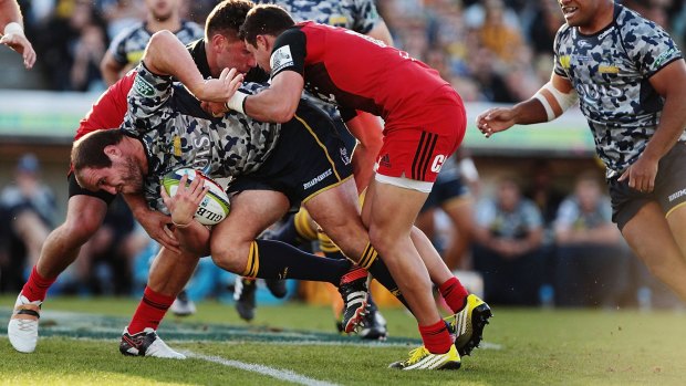 Brought down: Ben Alexander is tackled during the round nine Super Rugby match between the Brumbies and the Crusaders in Canberra.