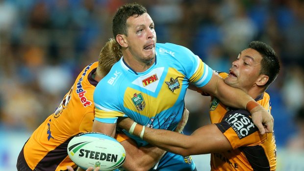 Greg Bird is tackled during the match between the Gold Coast Titans and the Brisbane Broncos.