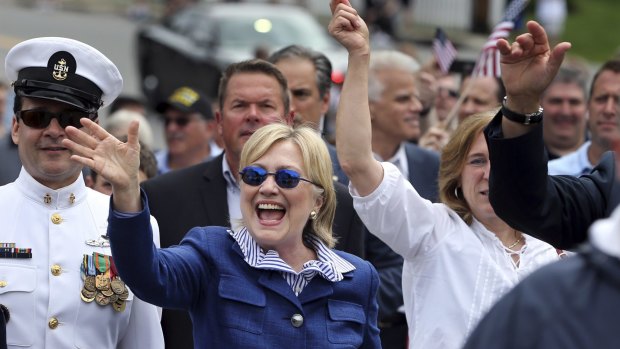 Democratic presidential candidate Hillary Clinton waves as she walks in a Memotial Day parade in New Castle.
