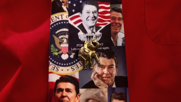 An attendee wears a tie featuring former US president Ronald Reagan and an elephant pin during a primary night rally for Republican presidential candidate Senator Marco Rubio, in Manchester, New Hampshire.