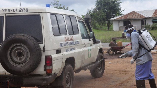 Ebola health workers spray disinfectant on an ambulance that was used to transport   two people suspected of having the Ebola virus  on the outskirts of Monrovia earlier this month. 