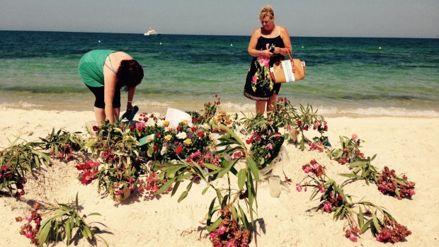 Flowers are laid on the Tunisian beach where a gunman killed 38 foreigners in June.