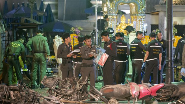 Police investigate the scene at the Erawan Shrine after the explosion in Bangkok.